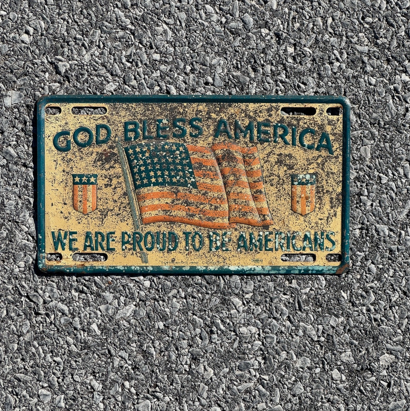 Photo of a 1940 Era God Bless America Booster License Plate Auto Proud to Be Americans Patriotic Flag USA WW2 God Bless America with original patina