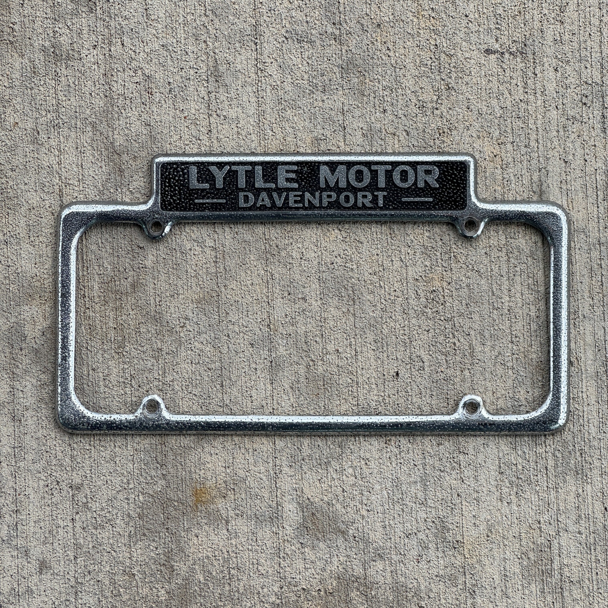 Photo of a 1940 Era Lytle Motor Davenport Iowa License Plate Frame Auto Tag Garage Decor Vintage DeSoto Plymouth Dealer Dealership with original patina