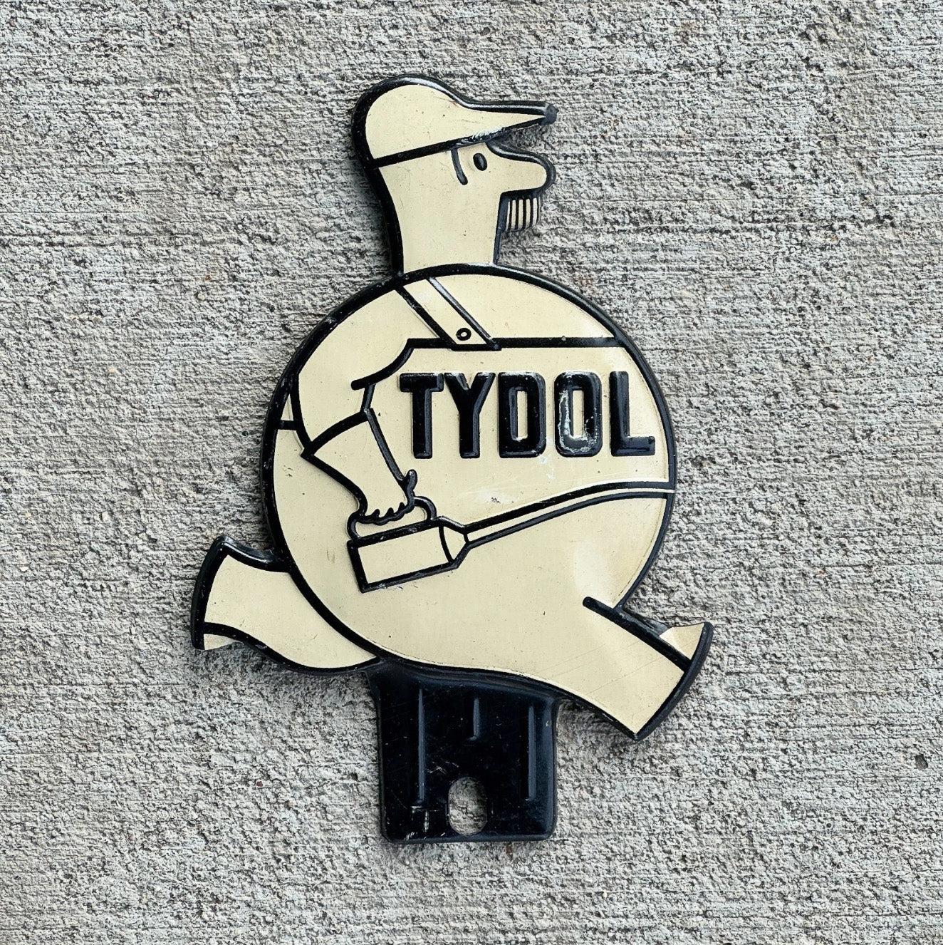 Photo of a 1940 Era Tydol License Plate Topper Auto Tag Garage Decor Vintage White Running Man Veedol Gas Oil Collectible with original patina