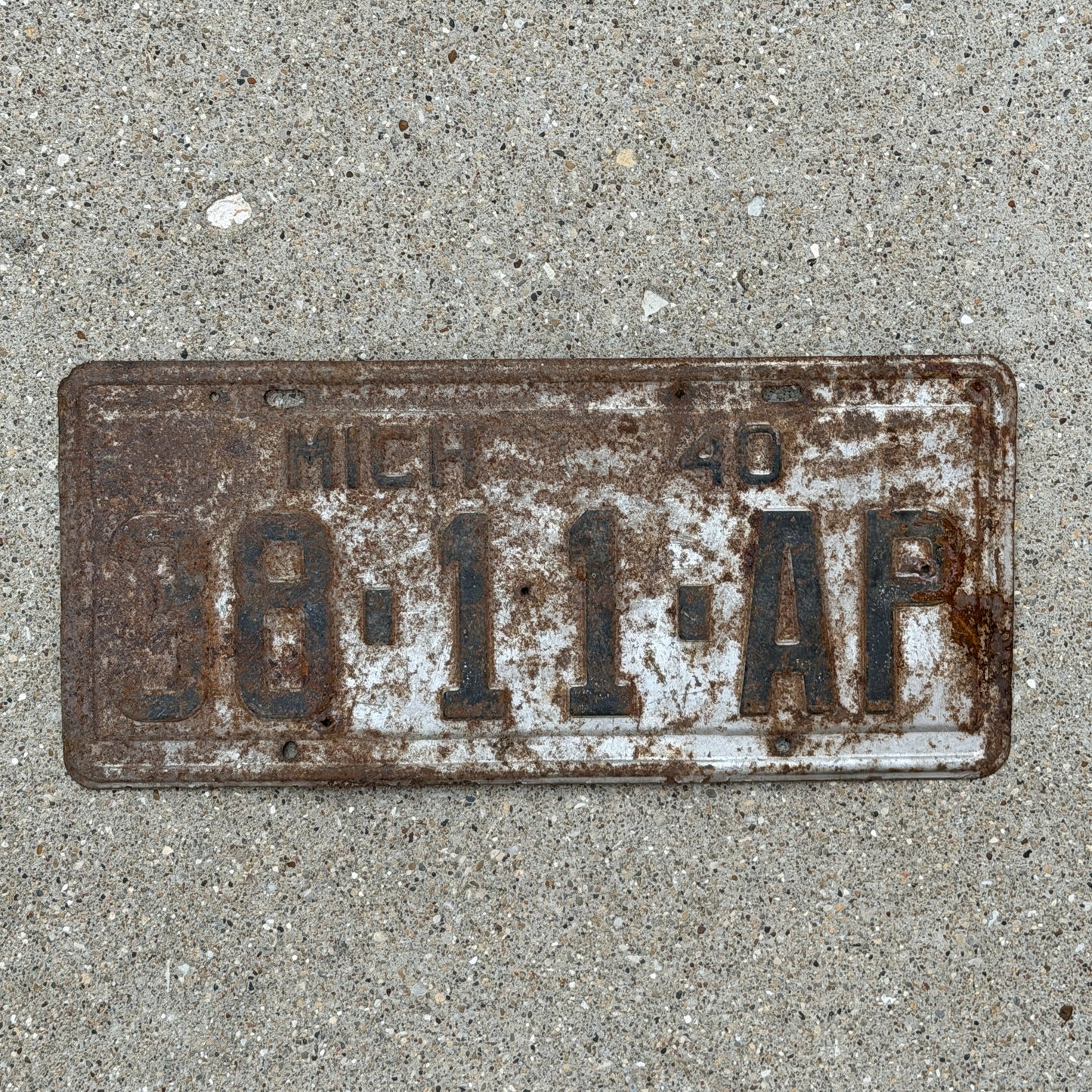 Photo of a 1940 Michigan Commercial License Plate Auto Tag Garage Decor Vintage 88 11 AP with original patina
