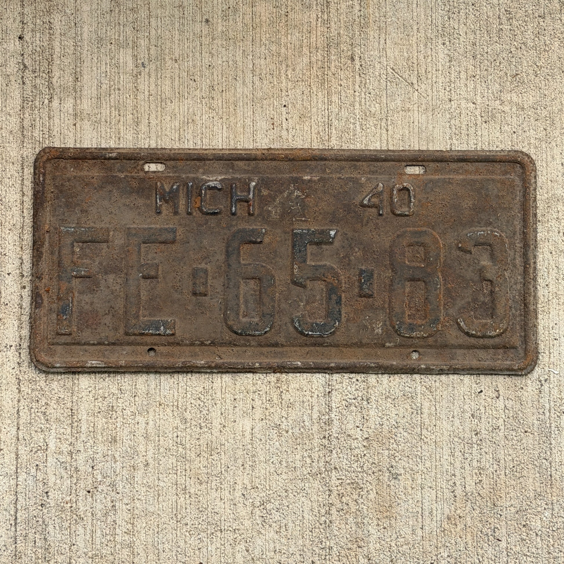 Photo of a 1940 Michigan License Plate Auto Tag Garage Decor Vintage FE 65 83 with original patina