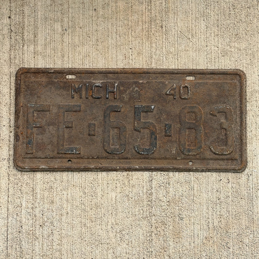 Photo of a 1940 Michigan License Plate Auto Tag Garage Decor Vintage FE 65 83 with original patina