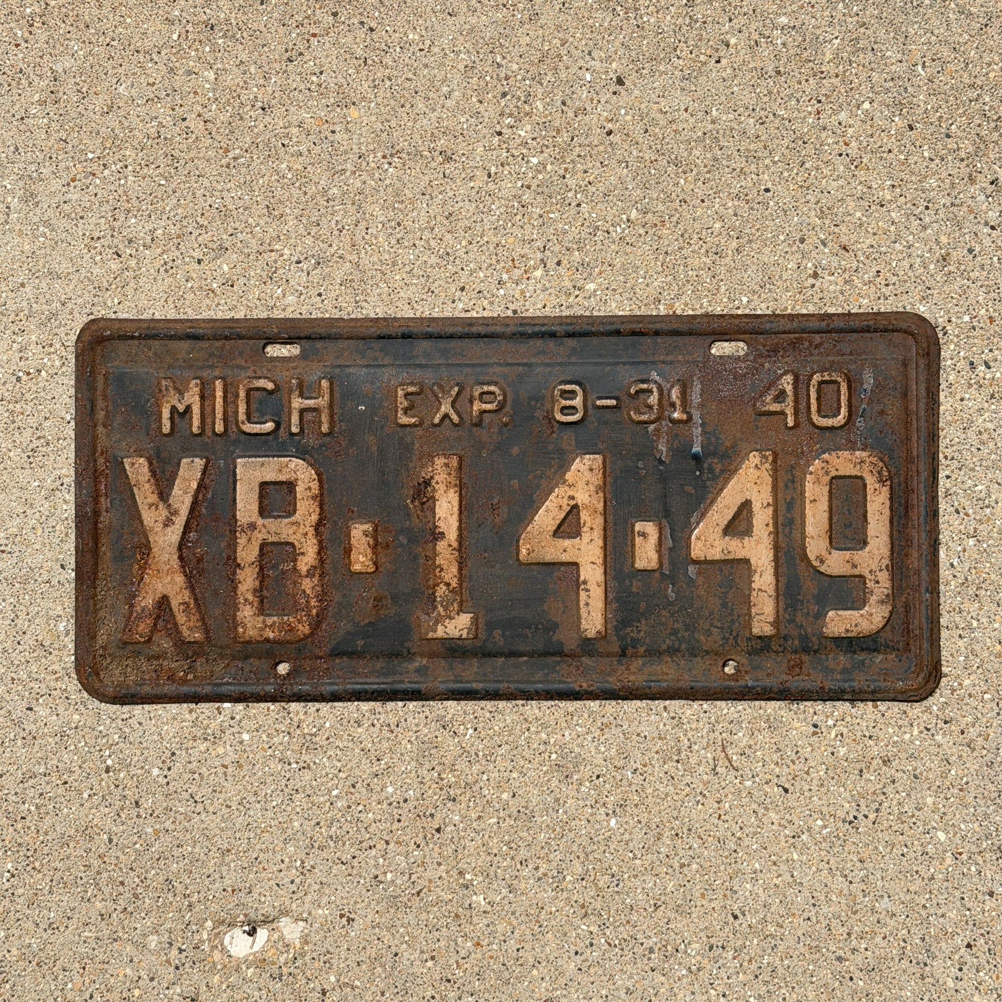 Photo of a 1940 Michigan License Plate Auto Tag Garage Decor Vintage Half Year XB 14 49 with original patina