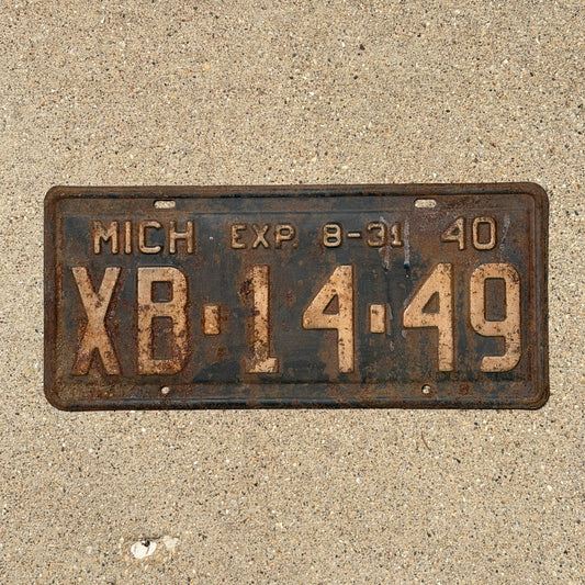 Photo of a 1940 Michigan License Plate Auto Tag Garage Decor Vintage Half Year XB 14 49 with original patina