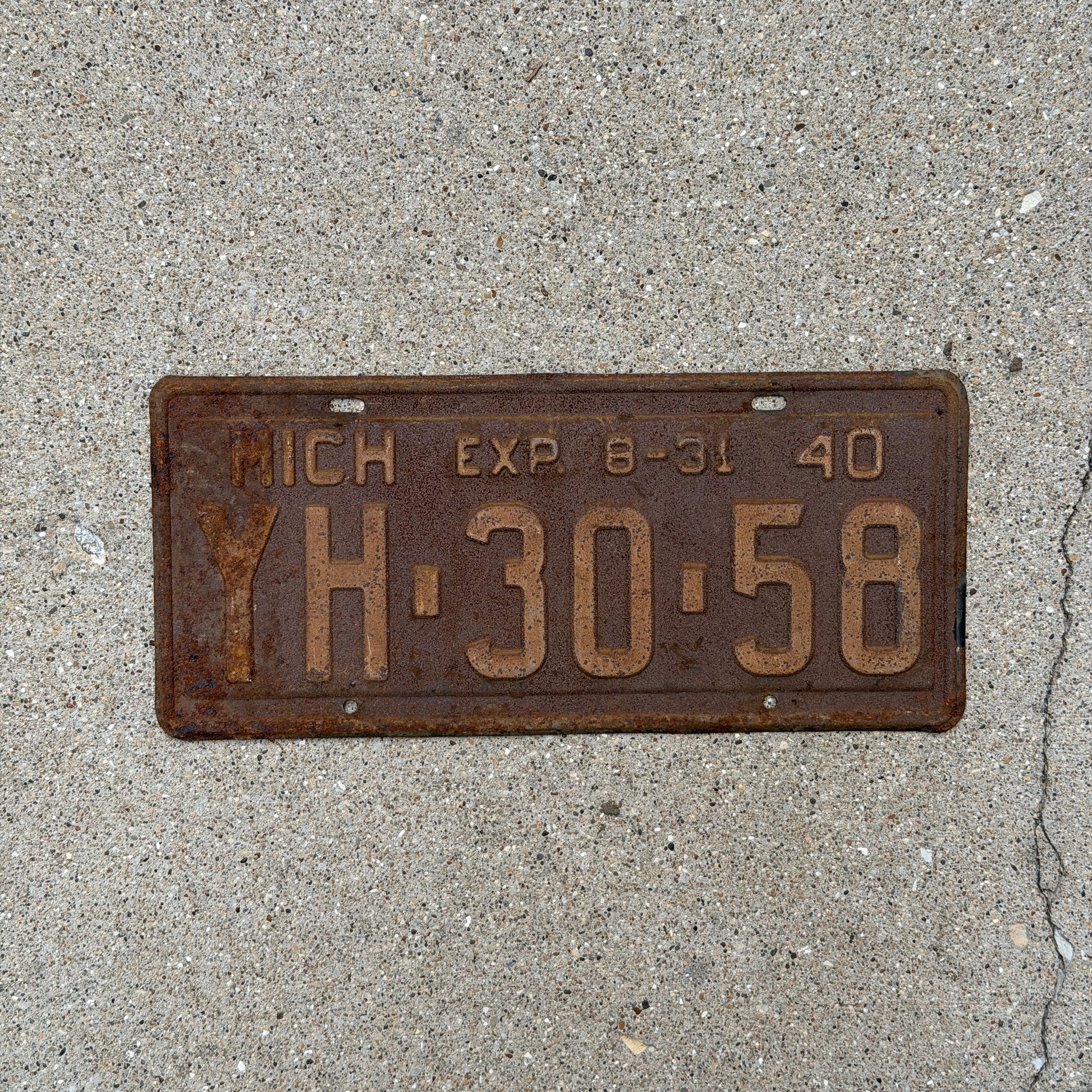 Photo of a 1940 Michigan License Plate Auto Tag Garage Decor Vintage Half Year YH 30 58 with original patina