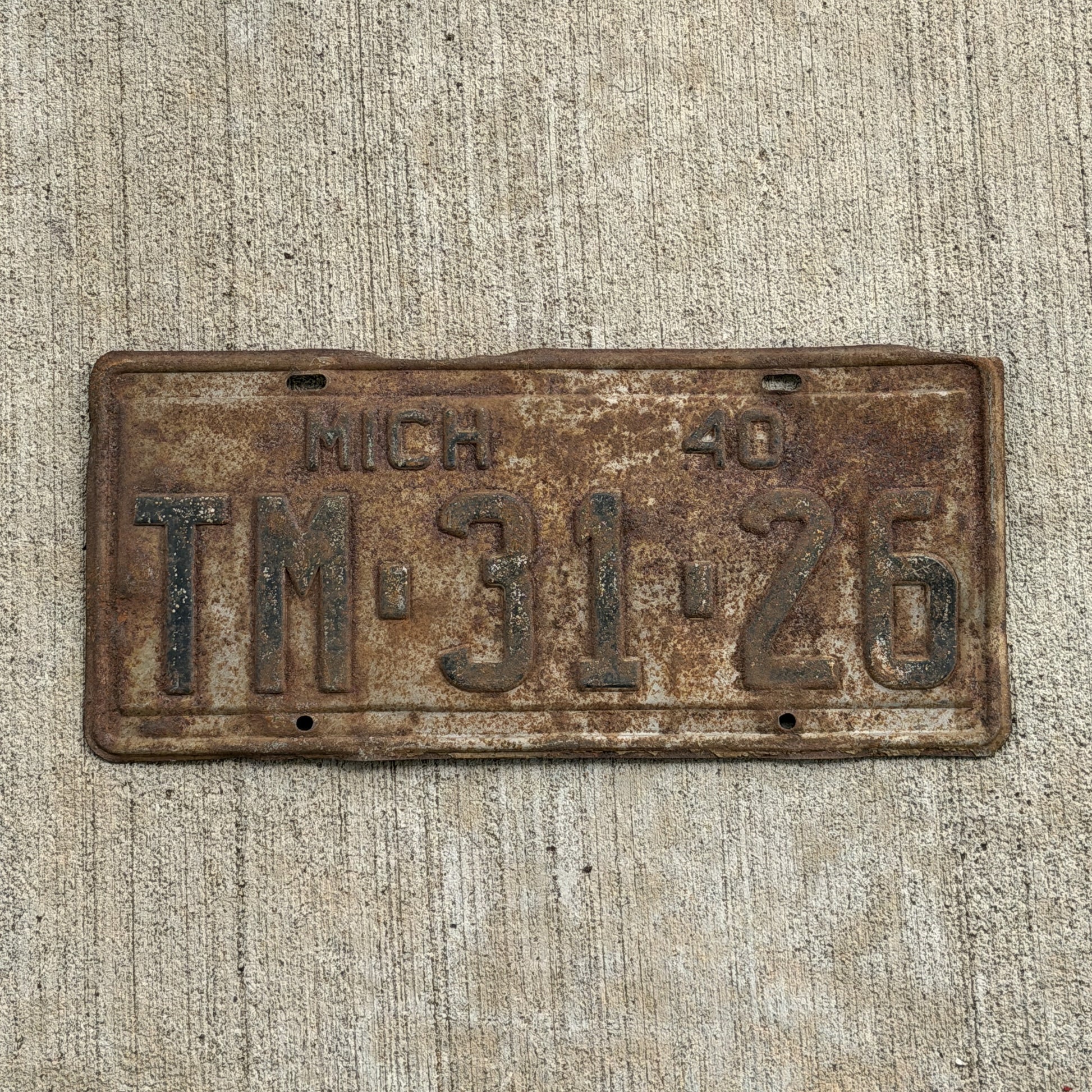 Photo of a 1940 Michigan License Plate Auto Tag Garage Decor Vintage TM 31 26 with original patina