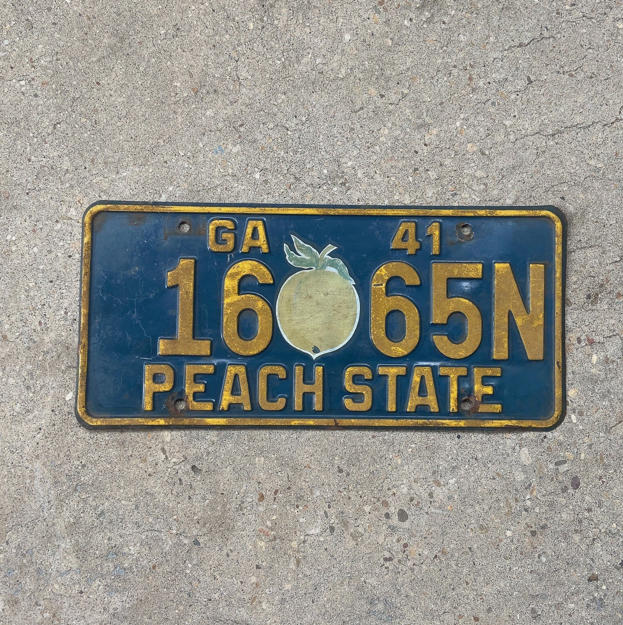 Photo of a 1941 Georgia License Plate Auto Tag Garage Decor Vintage Iconic Peach Graphic Original Decal 16 65 N with original patina