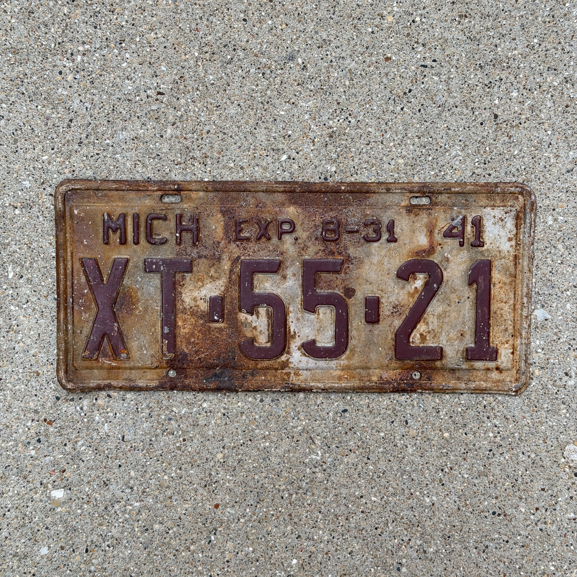 Photo of a 1941 Michigan License Plate Auto Tag Garage Decor Vintage Half Year XT 55 21 with original patina