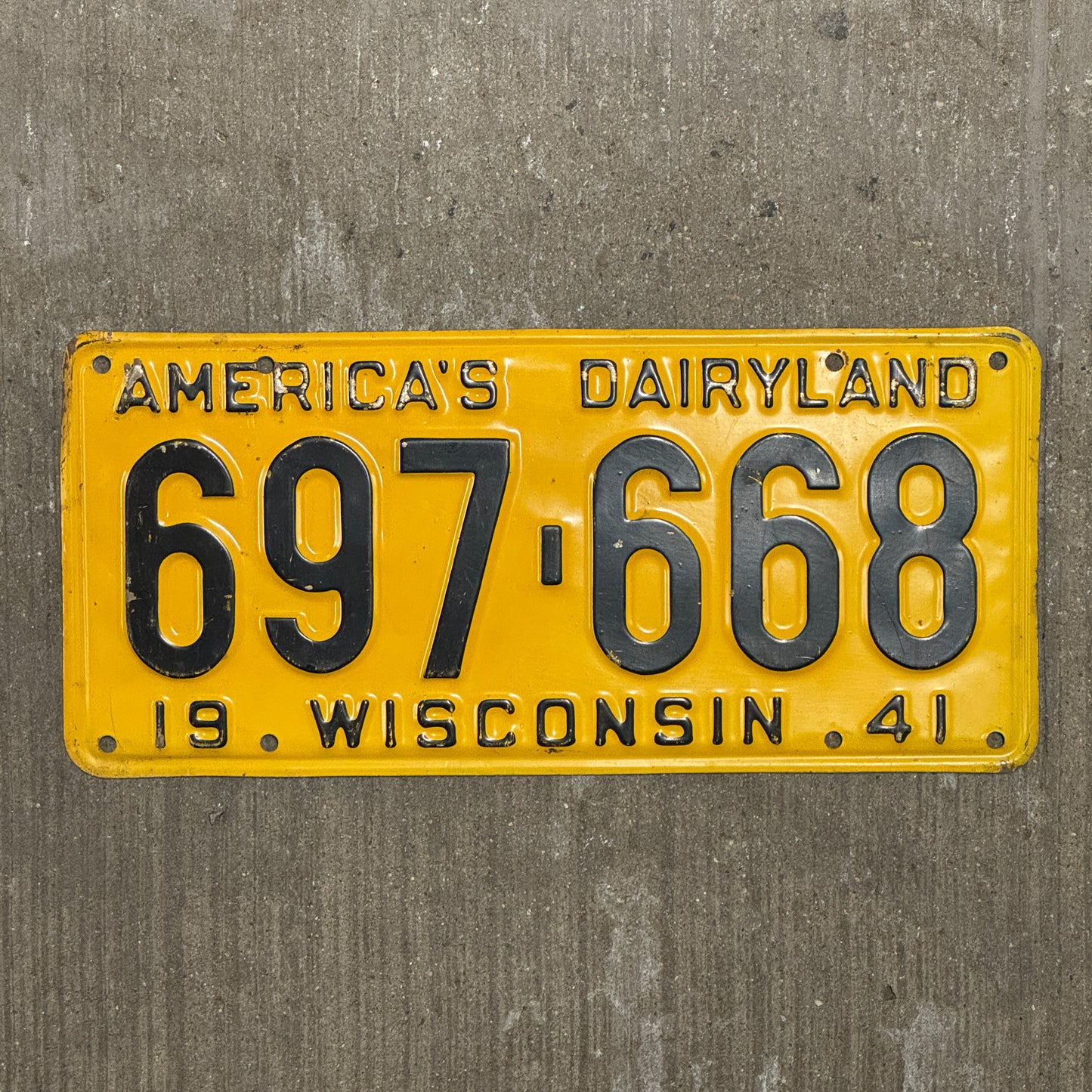 Photo of a 1941 Wisconsin License Plate Auto Tag Garage Decor Vintage 697 668 with original patina