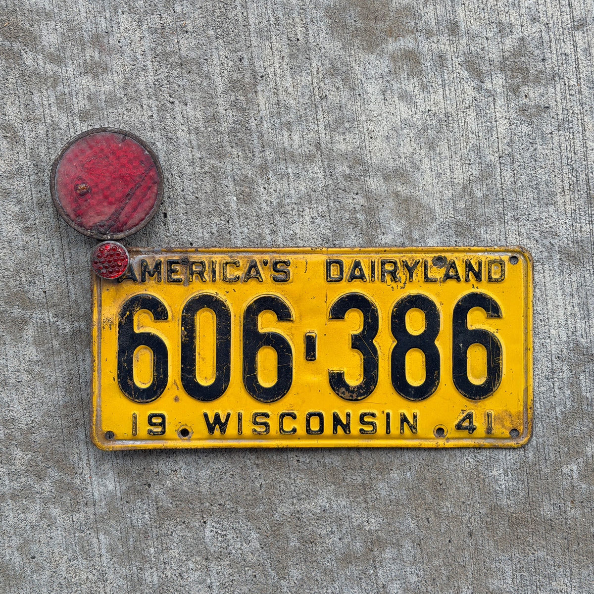Photo of a 1941 Wisconsin License Plate Auto Tag Garage Decor Vintage With Reflectors 606 386 with original patina