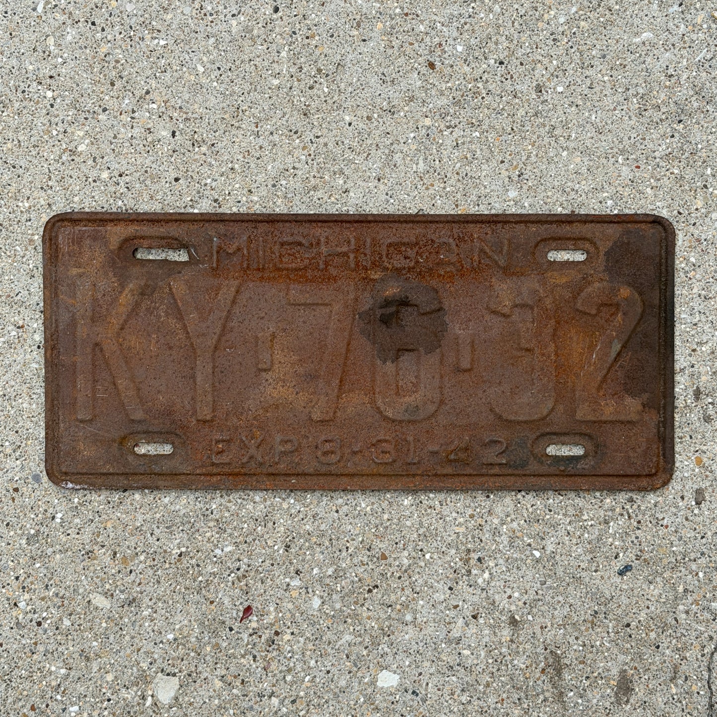 Photo of a 1942 Michigan License Plate Auto Tag Garage Decor Vintage Half Year KY 76 32 with original patina