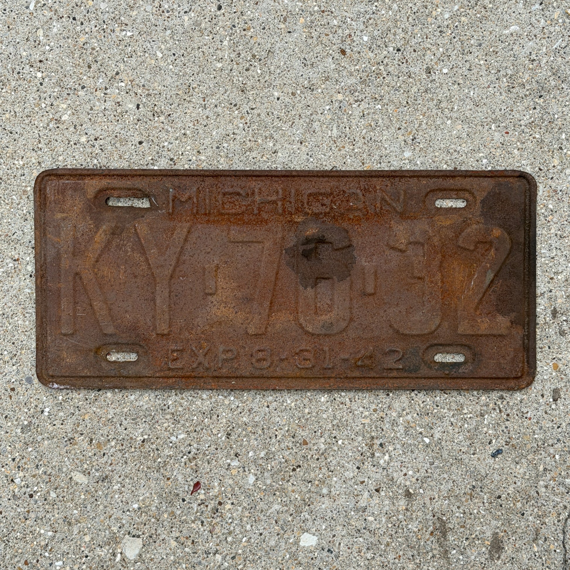 Photo of a 1942 Michigan License Plate Auto Tag Garage Decor Vintage Half Year KY 76 32 with original patina