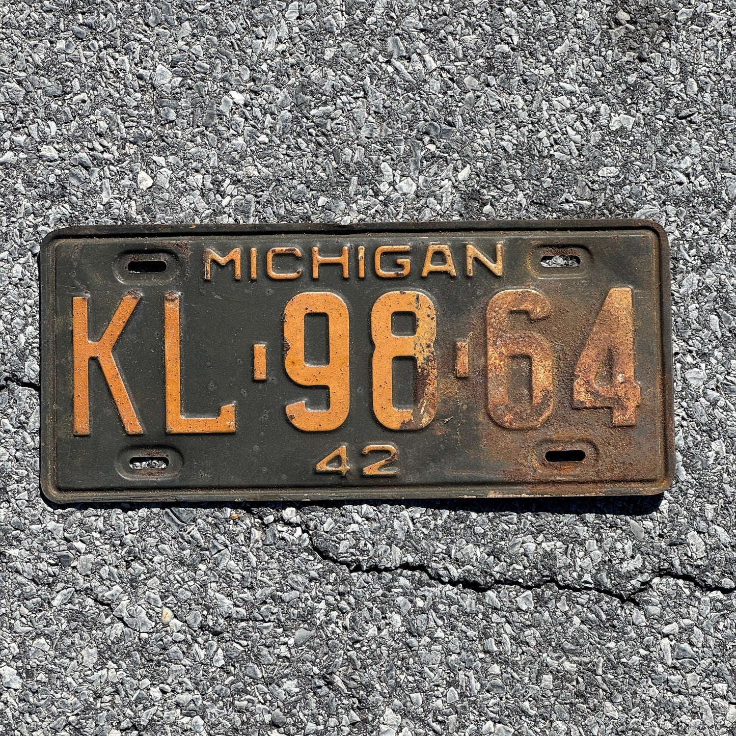 Photo of a 1942 Michigan License Plate Auto Tag Garage Decor Vintage KL 98 64