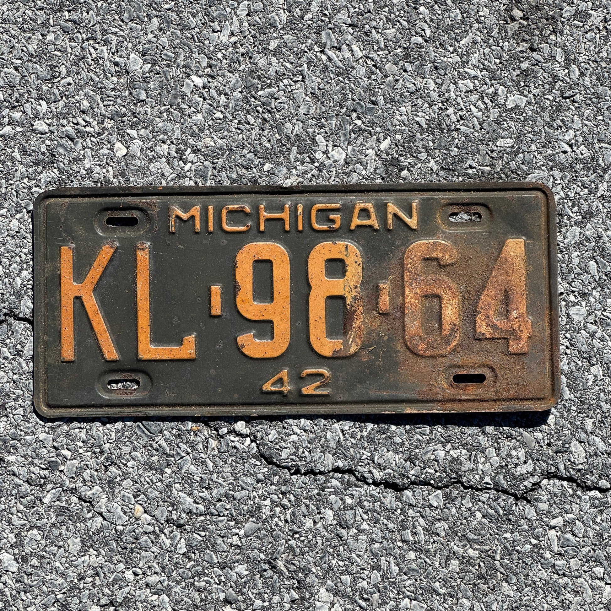 Photo of a 1942 Michigan License Plate Auto Tag Garage Decor Vintage KL 98 64