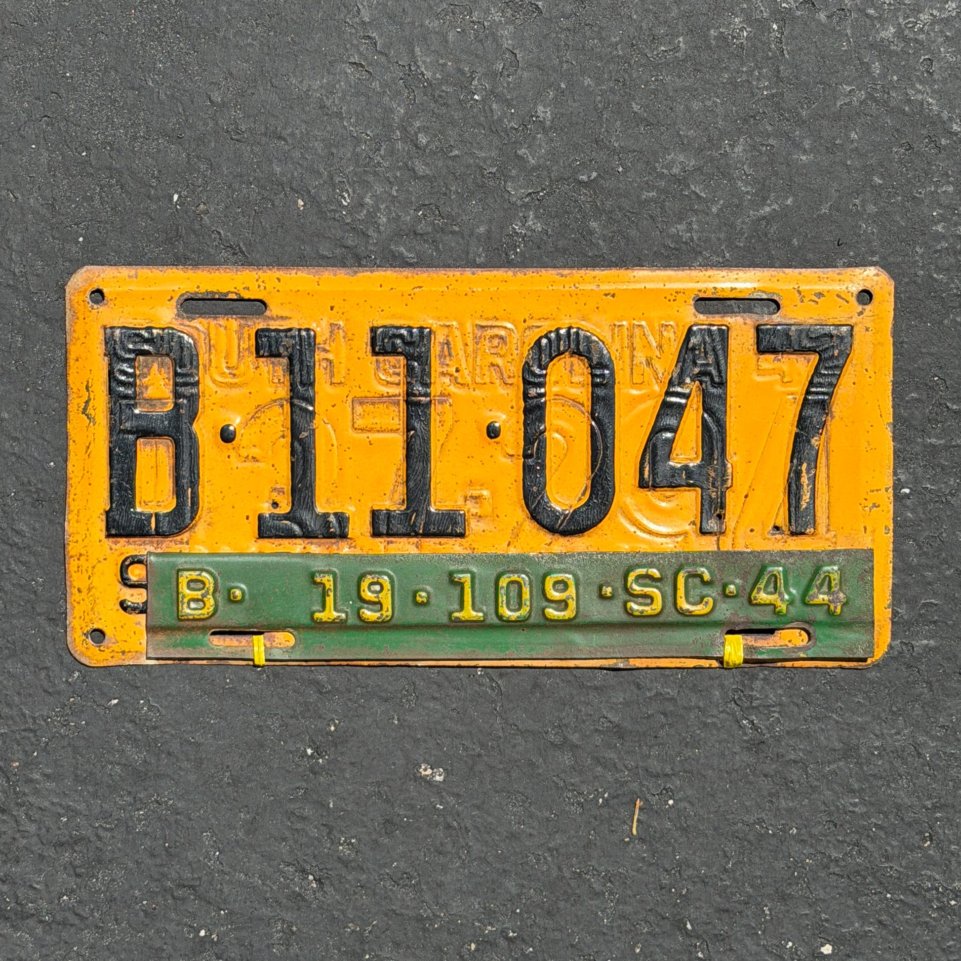 Photo of a 1943 1944 South Carolina License Plate Auto Tag Garage Decor Vintage WW2 Restamp B 11 047 with original patina