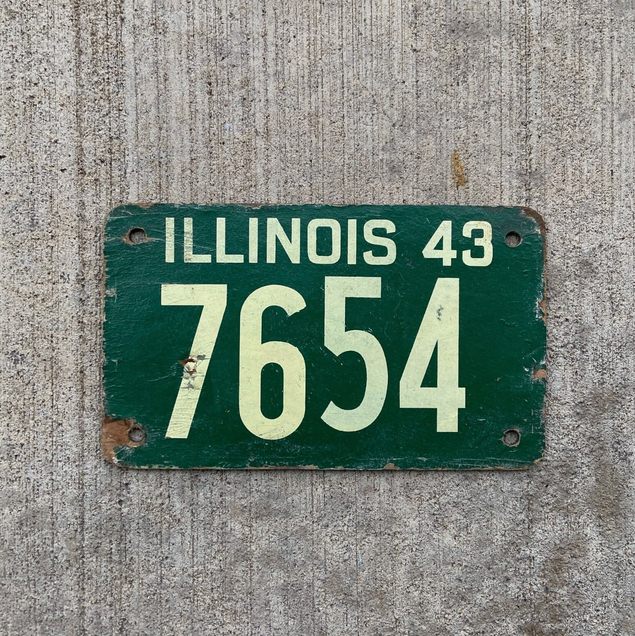 Photo of a 1943 Illinois Fiberboard License Plate Auto Tag Garage Decor Vintage Low Number Four Digit 7654 with original patina