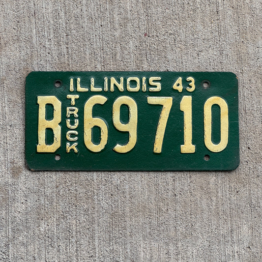 Photo of a 1943 Illinois Truck License Plate Auto Tag Garage Decor Vintage Embossed Text B 69710 with original patina