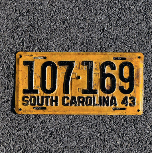 Photo of a 1943 South Carolina License Plate Auto Tag Garage Decor Vintage Restamp WWII War Year 107 169 with original patina