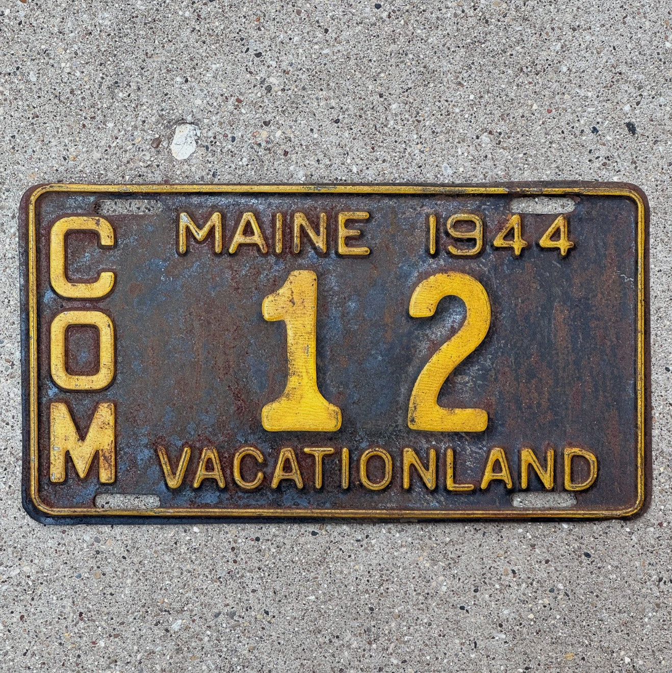 Photo of a 1944 Maine Truck License Plate Auto Tag Garage Decor Vintage Low Number Two Digit 12 with original patina