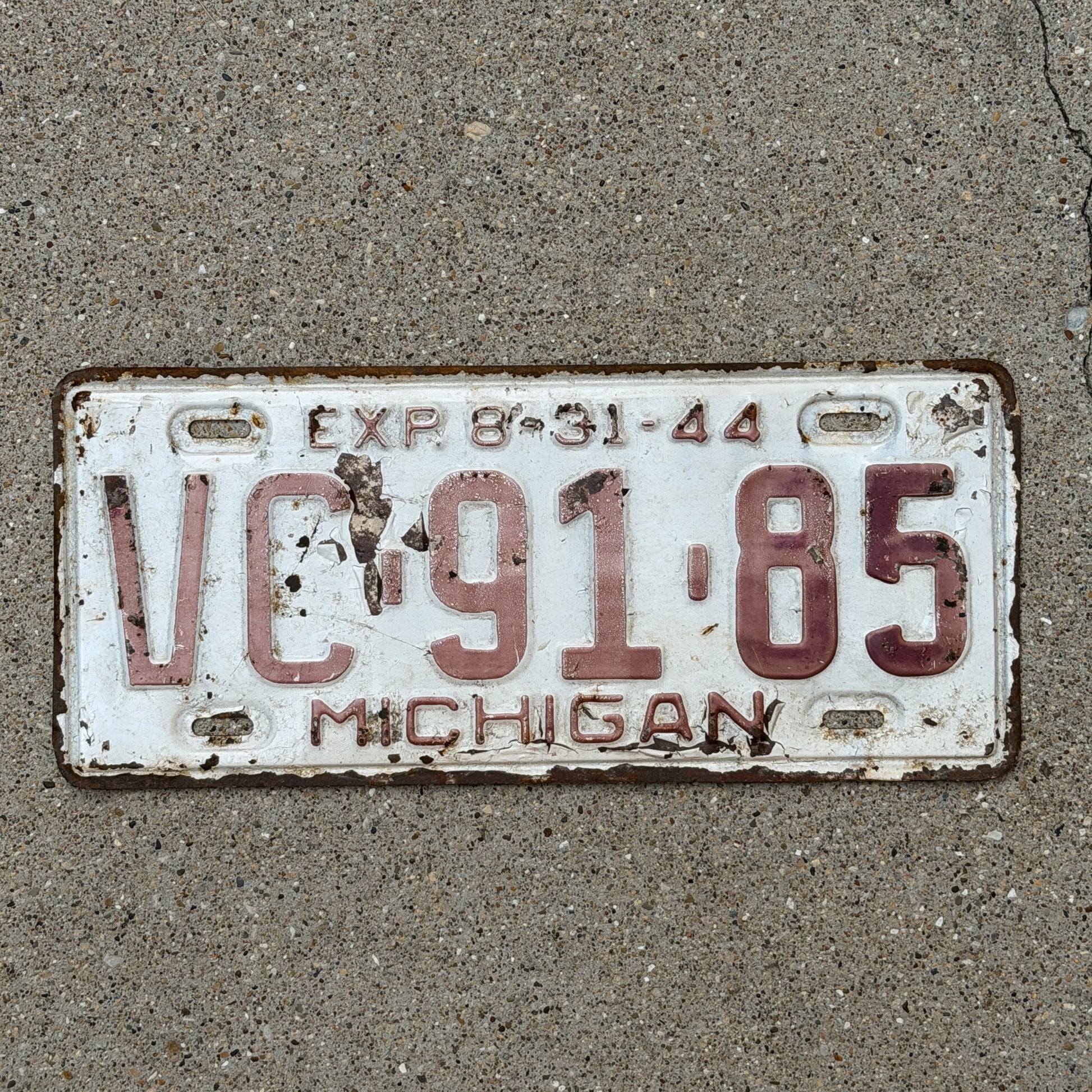 Photo of a 1944 Michigan License Plate Auto Tag Garage Decor Vintage Half Year VC 91 85 with original patina