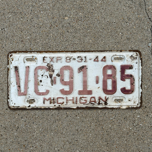 Photo of a 1944 Michigan License Plate Auto Tag Garage Decor Vintage Half Year VC 91 85 with original patina