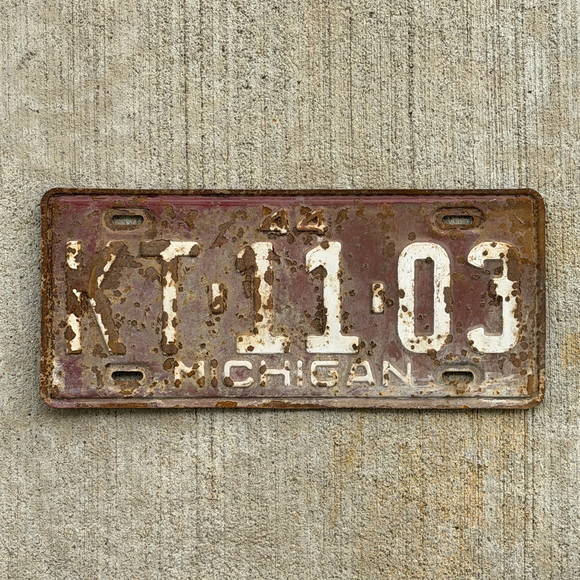 Photo of a 1944 Michigan License Plate Auto Tag Garage Decor Vintage KT 11 03 with original patina