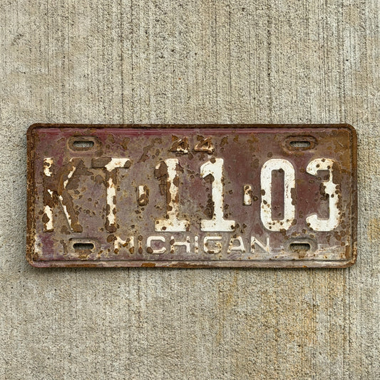 Photo of a 1944 Michigan License Plate Auto Tag Garage Decor Vintage KT 11 03 with original patina
