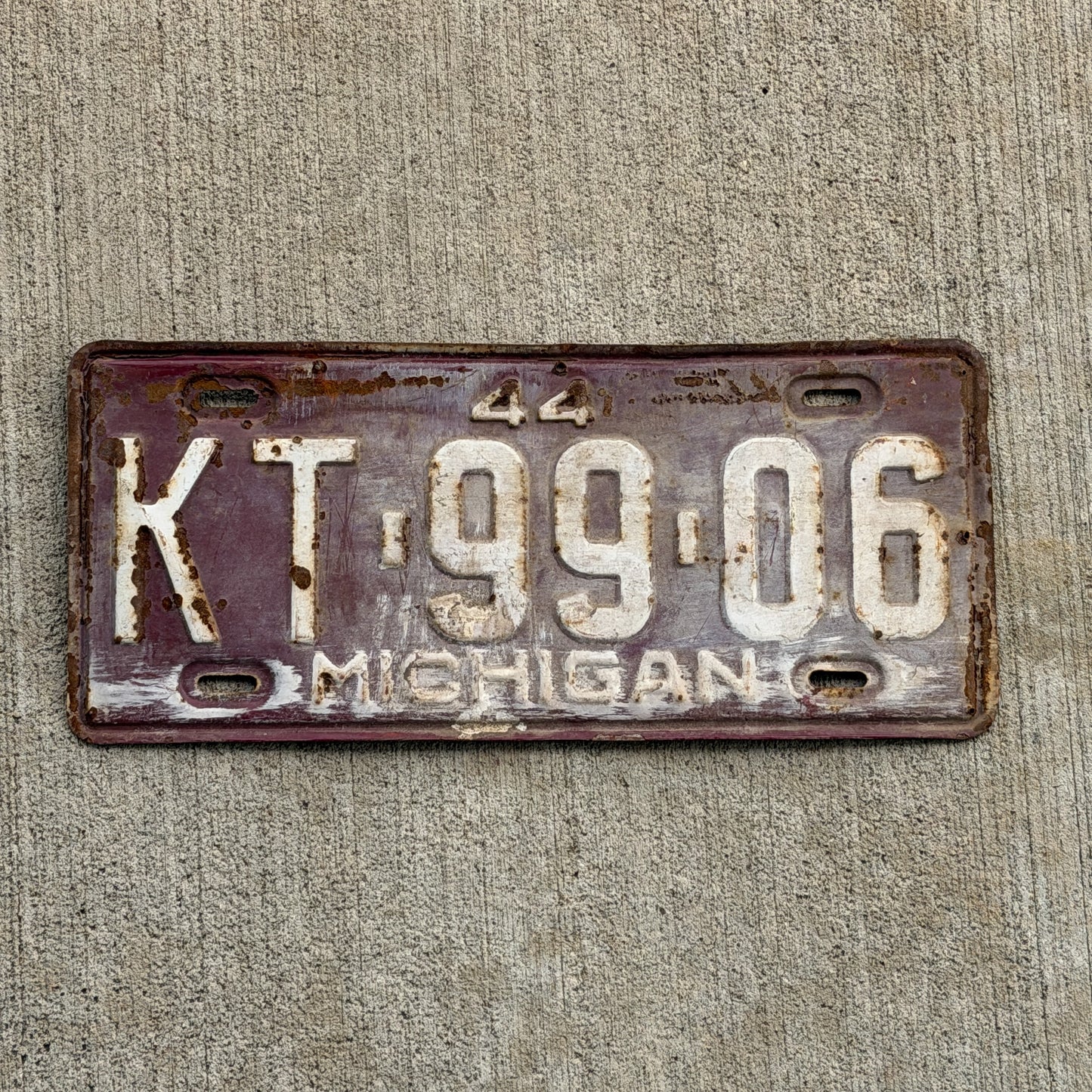 Photo of a 1944 Michigan License Plate Auto Tag Garage Decor Vintage KT 99 06 with original patina
