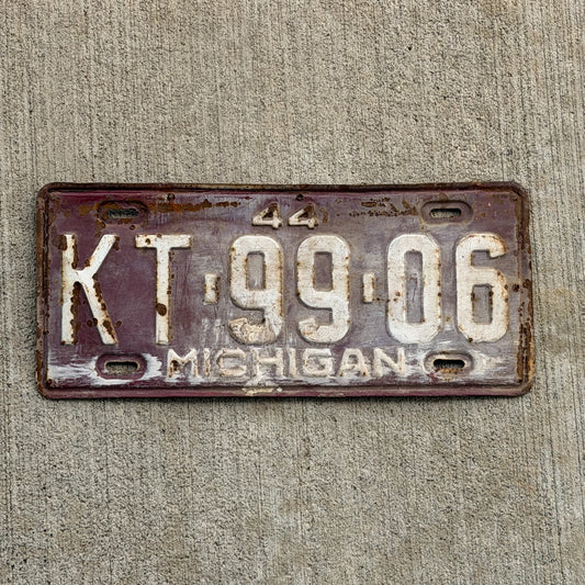 Photo of a 1944 Michigan License Plate Auto Tag Garage Decor Vintage KT 99 06 with original patina