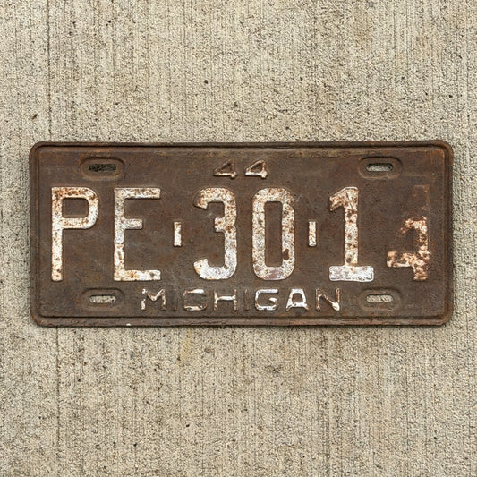 Photo of a 1944 Michigan License Plate Auto Tag Garage Decor Vintage PE 30 14 with original patina