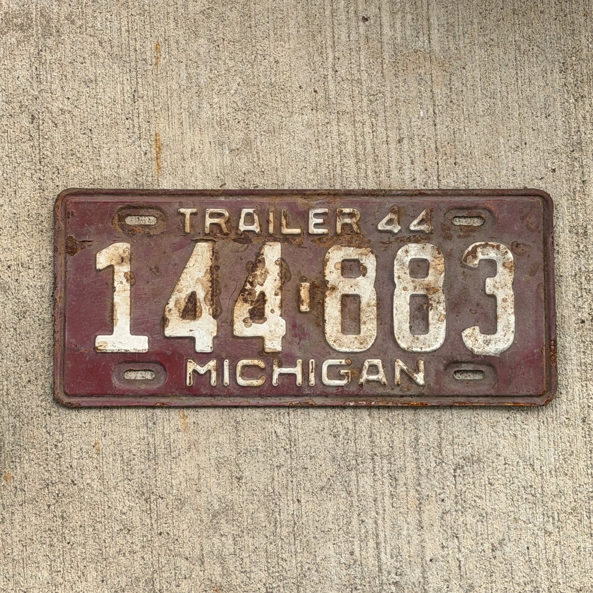 Photo of a 1944 Michigan Trailer License Plate Auto Tag Garage Decor Vintage 144 883 with original patina