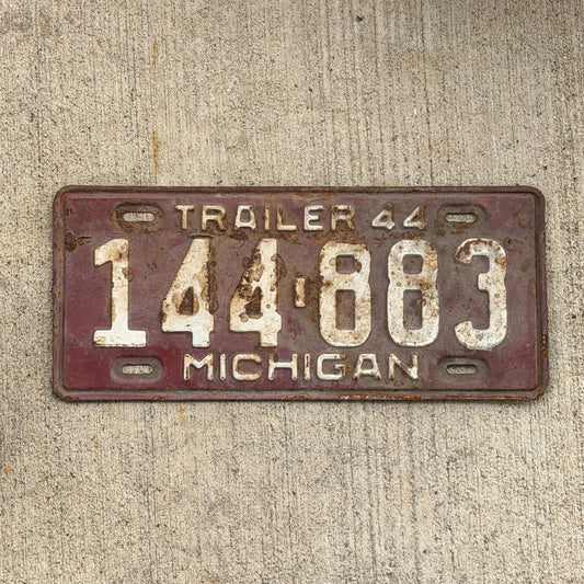 Photo of a 1944 Michigan Trailer License Plate Auto Tag Garage Decor Vintage 144 883 with original patina