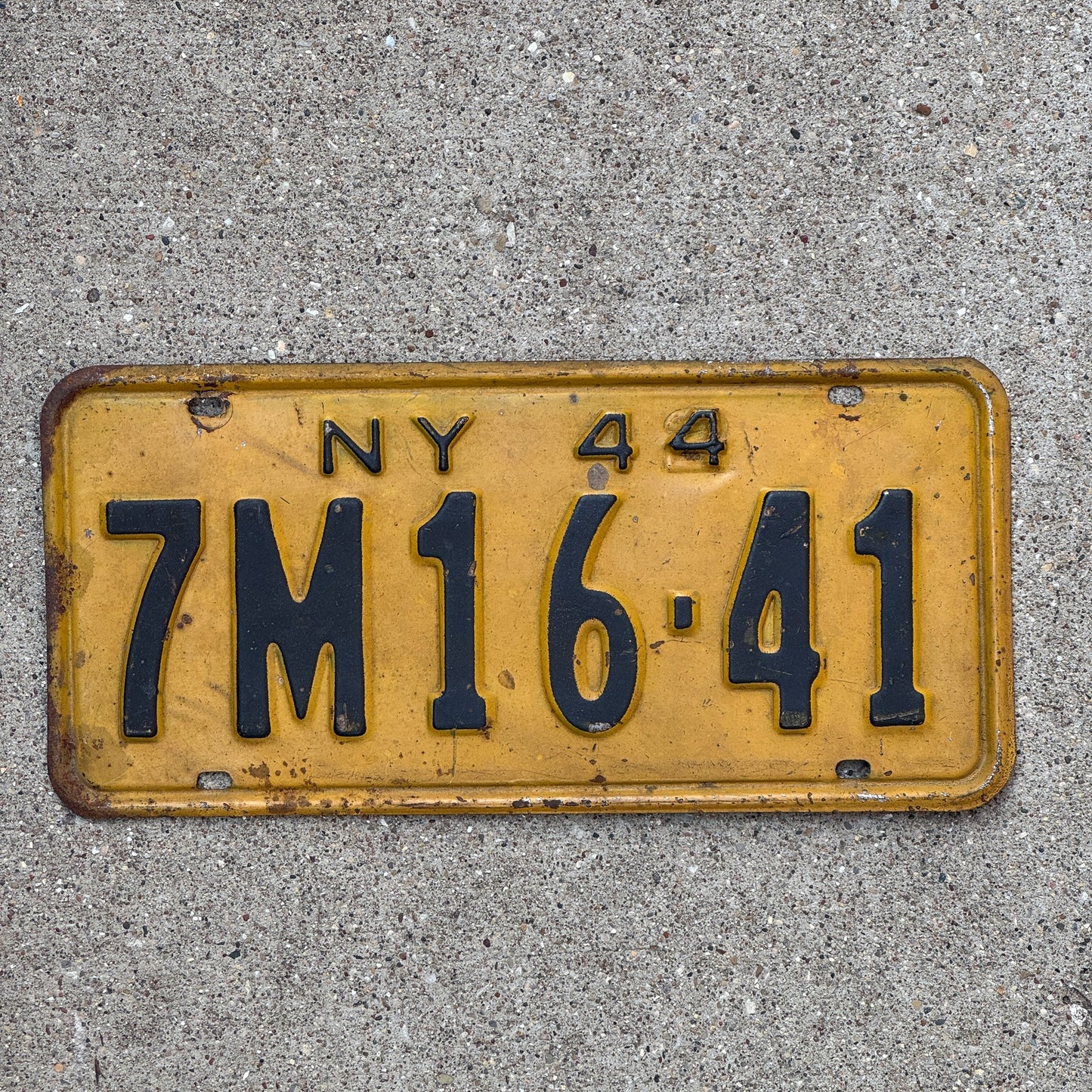 Photo of a 1944 New York License Plate Auto Tag Garage Decor Vintage Restamp WWII 7M 1641