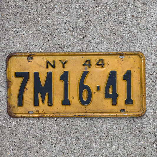 Photo of a 1944 New York License Plate Auto Tag Garage Decor Vintage Restamp WWII 7M 1641