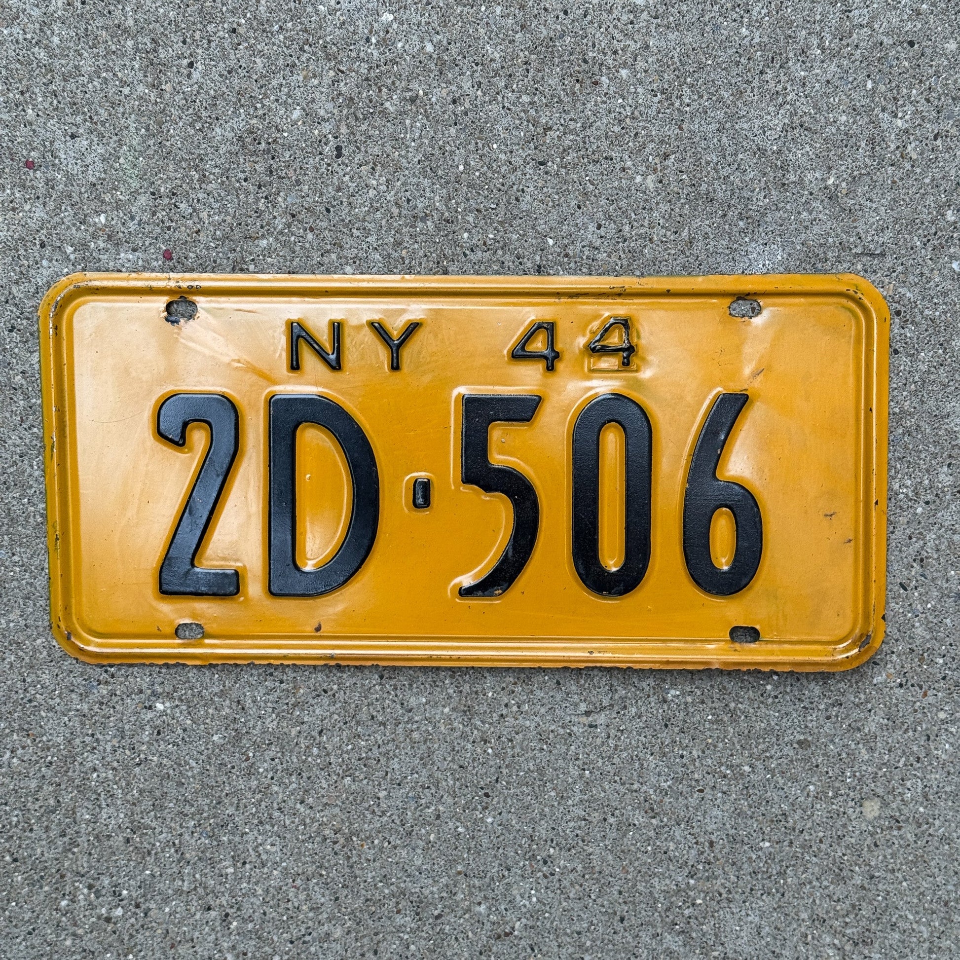 Photo of a 1944 New York License Plate Auto Tag Garage Decor Vintage Restamped War Year 2D 506 with original patina