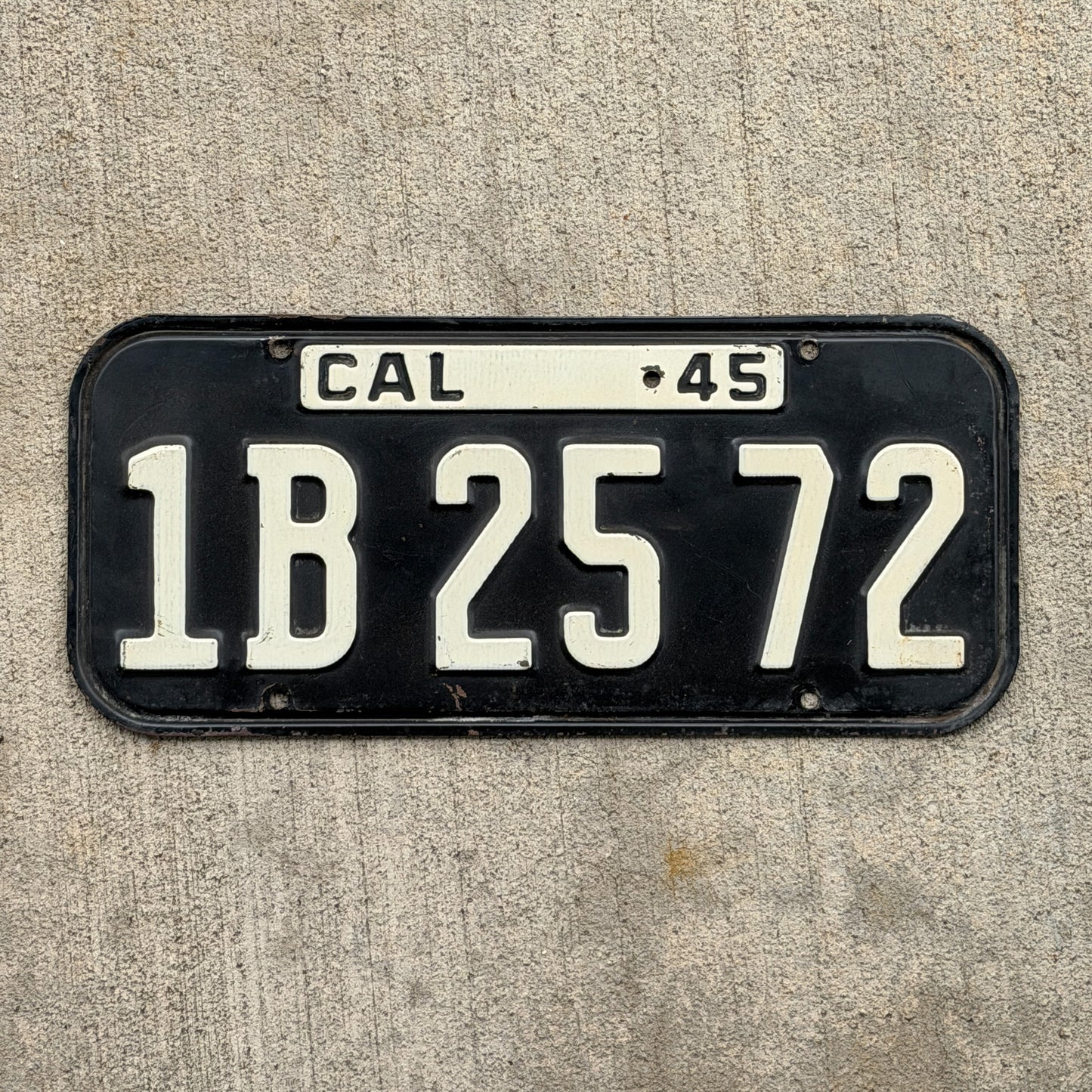 Photo of a 1945 California License Plate Auto Tag Garage Decor Vintage YOM Number DMV Clear 1B 25 72 with original patina