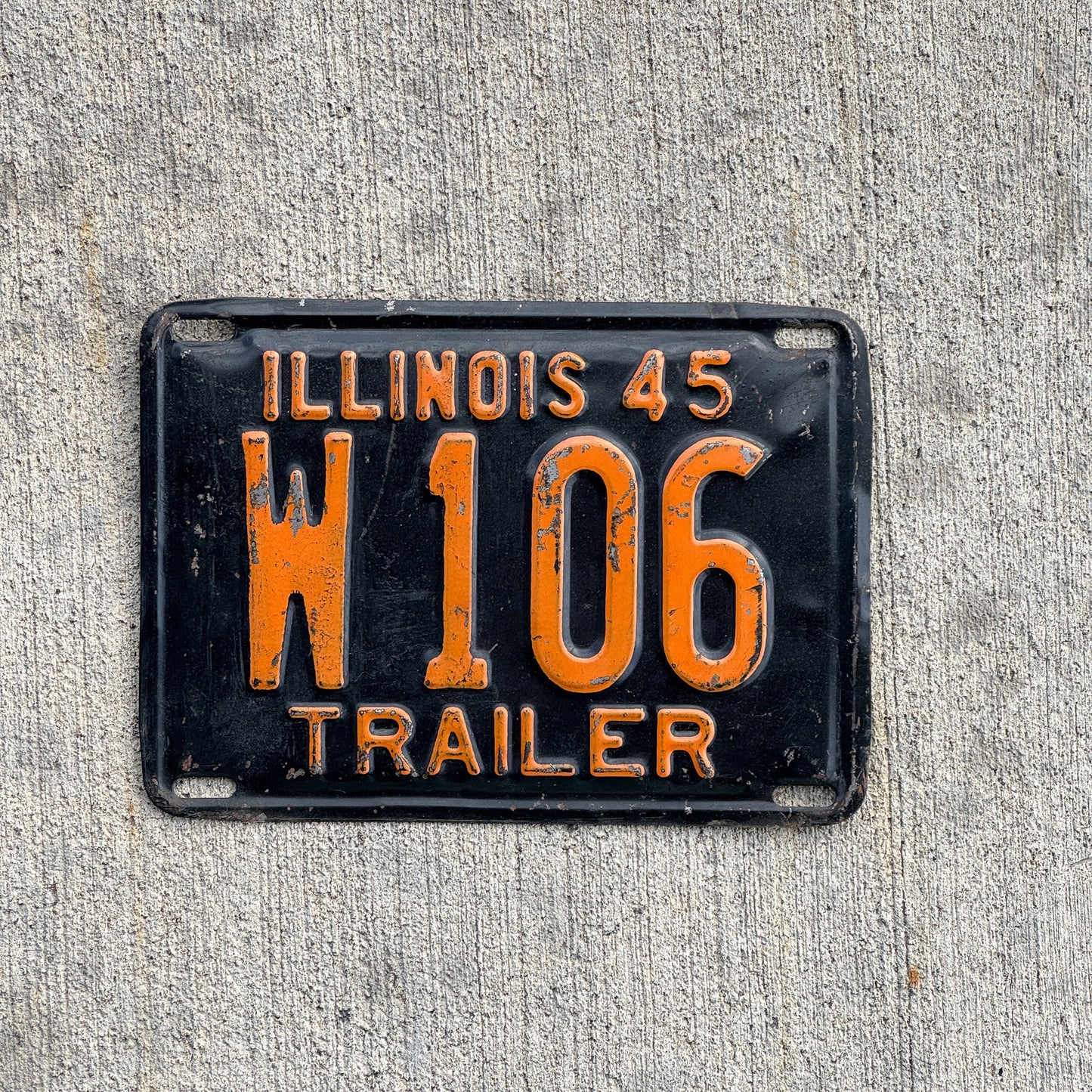 Photo of a 1945 Illinois Trailer License Plate Auto Tag Garage Decor Vintage Low Number Three Digit W 106 with original patina