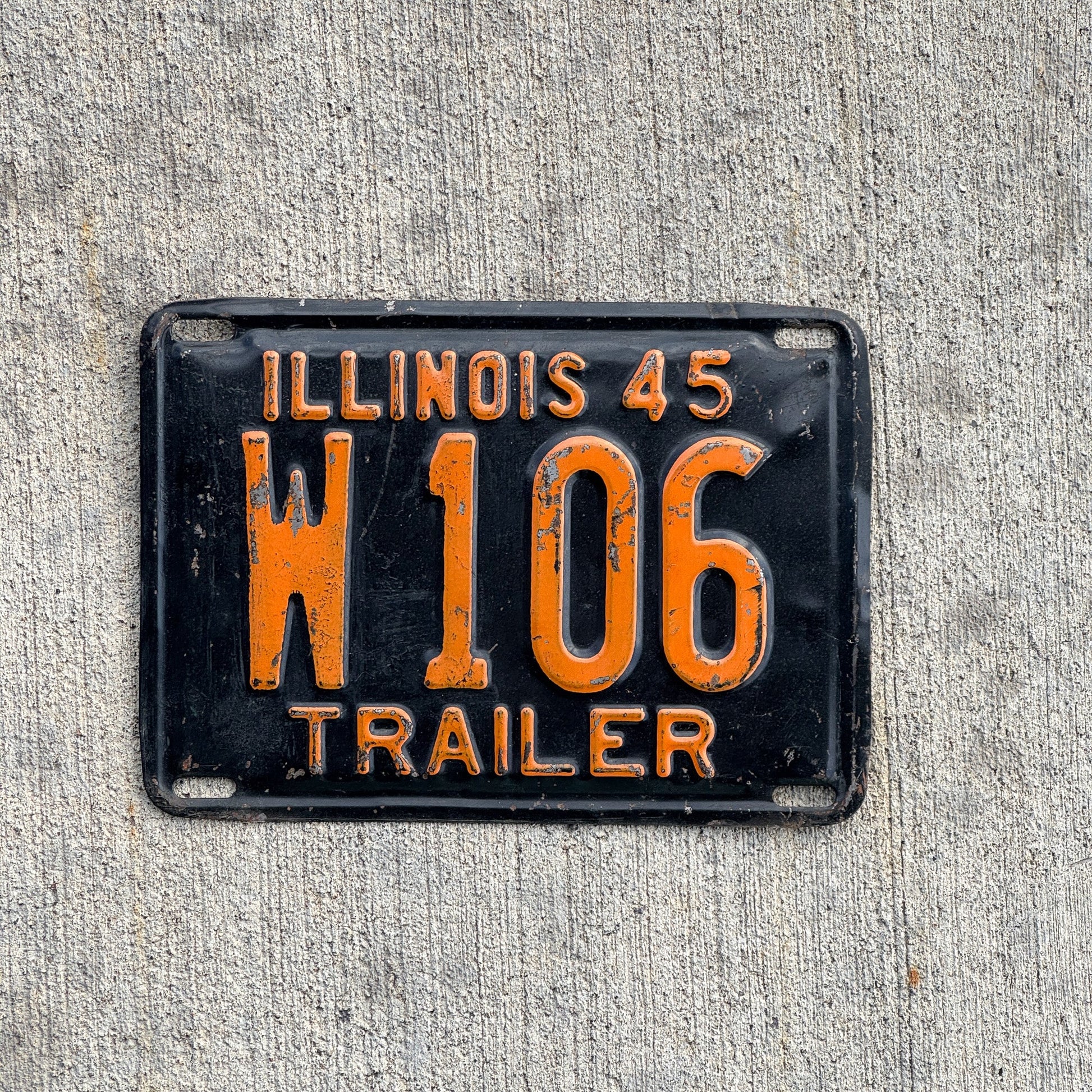 Photo of a 1945 Illinois Trailer License Plate Auto Tag Garage Decor Vintage Low Number Three Digit W 106 with original patina