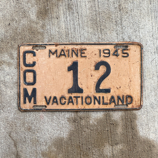 Photo of a 1945 Maine Commercial License Plate Auto Tag Garage Decor Vintage Low Number Two Digit 12 with original patina