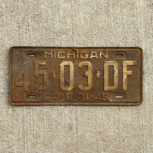Photo of a 1945 Michigan Commercial License Plate Auto Tag Garage Decor Vintage Half Year 45 03 DF with original patina