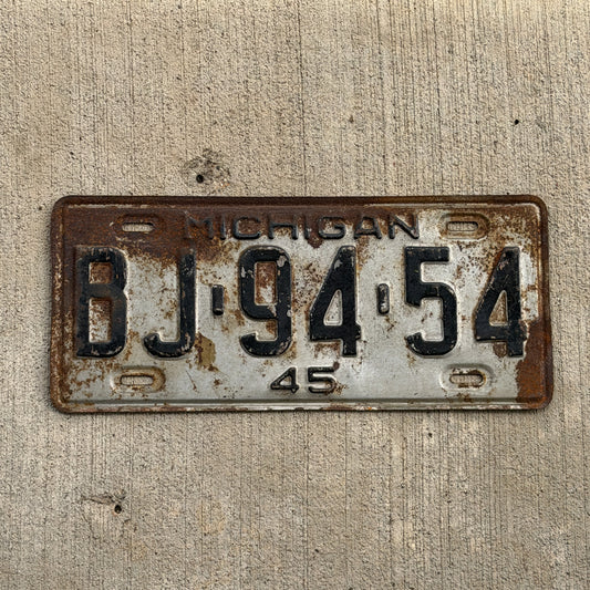 Photo of a 1945 Michigan License Plate Auto Tag Garage Decor Vintage BJ 94 54 with original patina