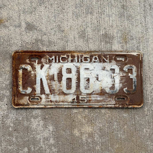 Photo of a 1945 Michigan License Plate Auto Tag Garage Decor Vintage CK 86 33 with original patina