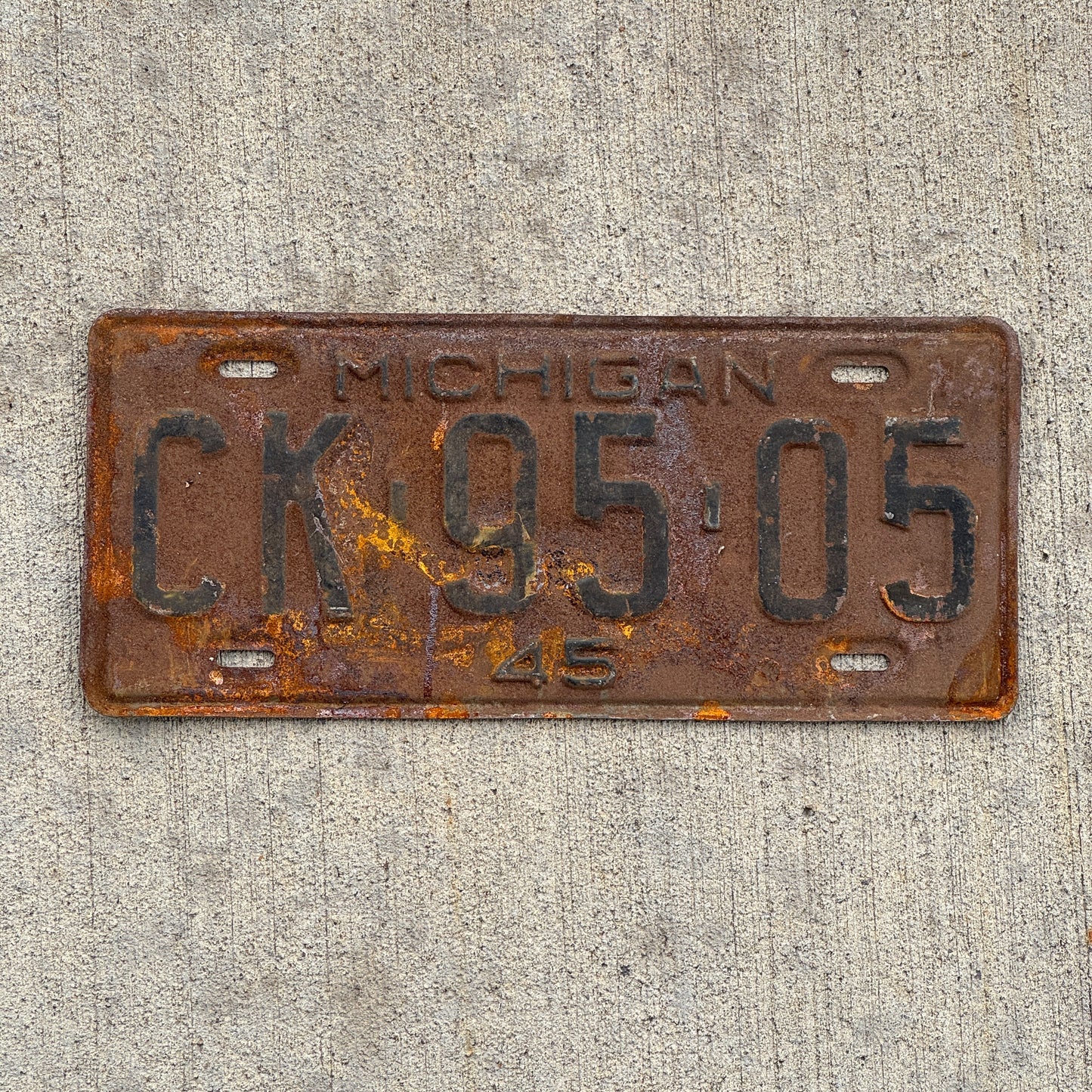 Photo of a 1945 Michigan License Plate Auto Tag Garage Decor Vintage CK 95 05 with original patina