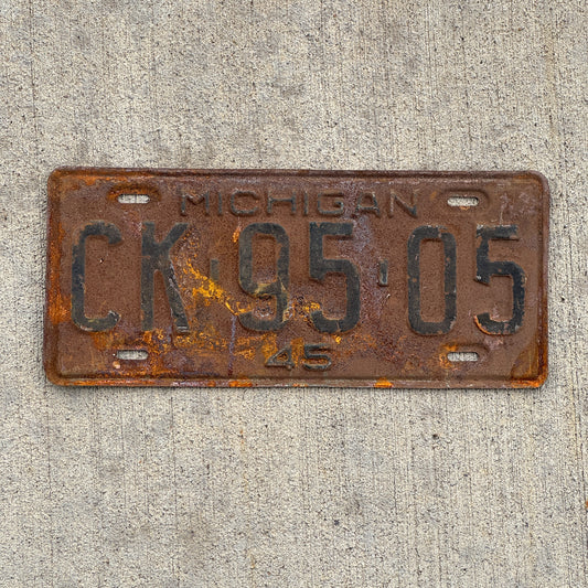 Photo of a 1945 Michigan License Plate Auto Tag Garage Decor Vintage CK 95 05 with original patina