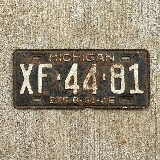 Photo of a 1945 Michigan License Plate Auto Tag Garage Decor Vintage Half Year XF 44 81 with original patina