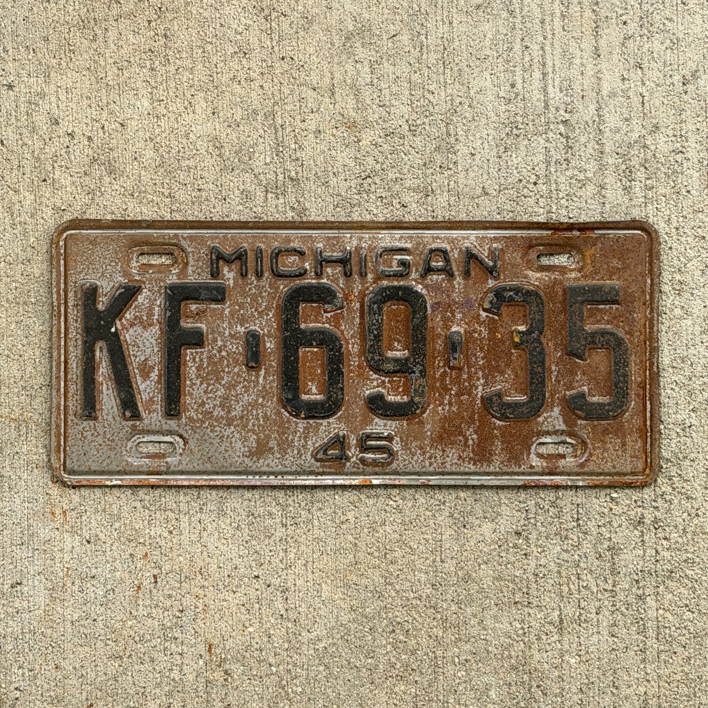 Photo of a 1945 Michigan License Plate Auto Tag Garage Decor Vintage KF 69 35 with original patina