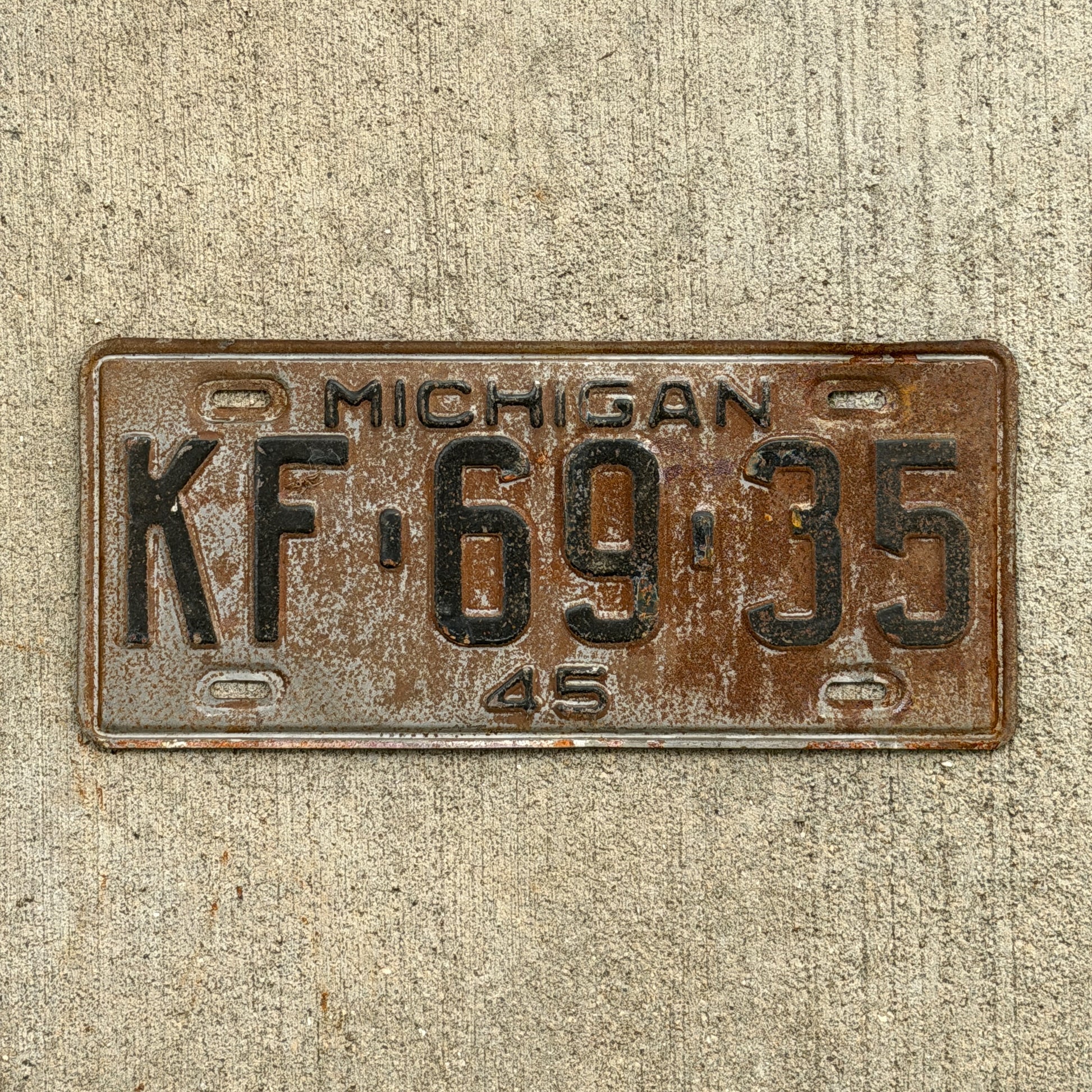 Photo of a 1945 Michigan License Plate Auto Tag Garage Decor Vintage KF 69 35 with original patina