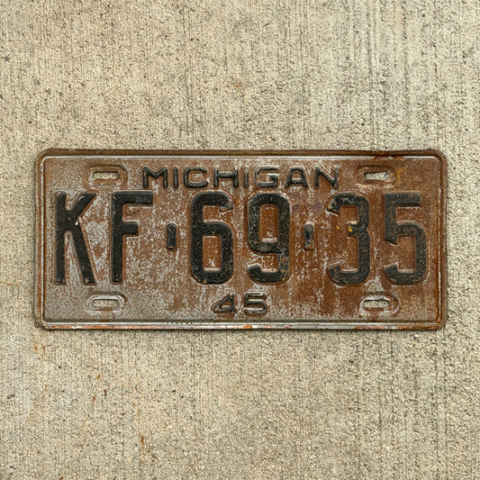 Photo of a 1945 Michigan License Plate Auto Tag Garage Decor Vintage KF 69 35 with original patina