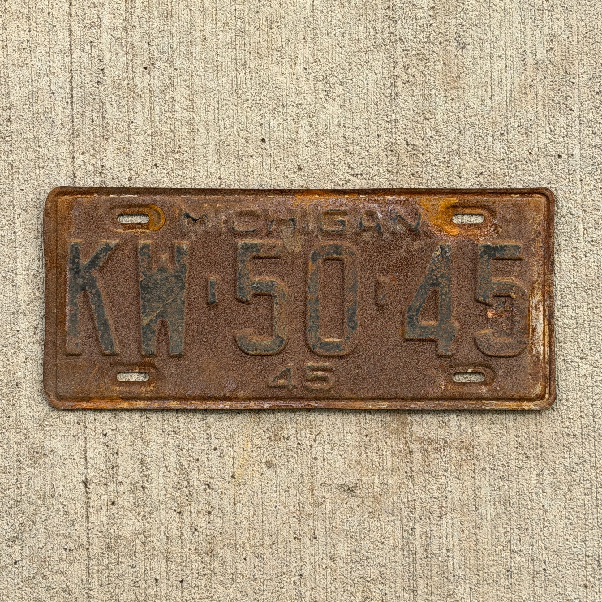 Photo of a 1945 Michigan License Plate Auto Tag Garage Decor Vintage KW 50 45 with original patina