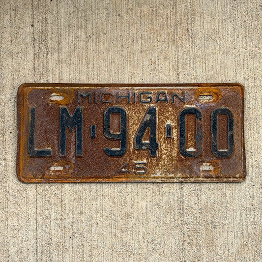 Photo of a 1945 Michigan License Plate Auto Tag Garage Decor Vintage LM 94 00 with original patina